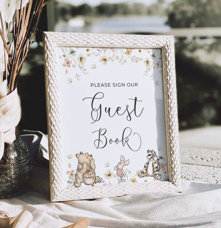 Winnie the Pooh themed guest book sign with characters, perfect for gender-neutral baby shower party decorations.