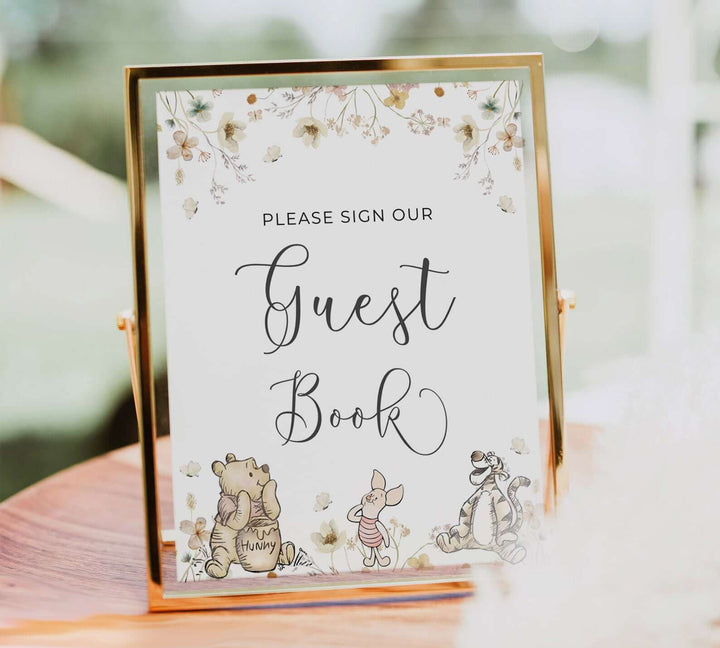 Winnie The Pooh themed guest book sign with gender neutral floral design, perfect for baby shower party decorations.