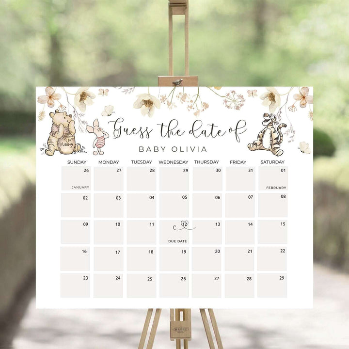 Winnie The Pooh baby due date calendar for gender neutral baby shower, featuring adorable characters on an easel.