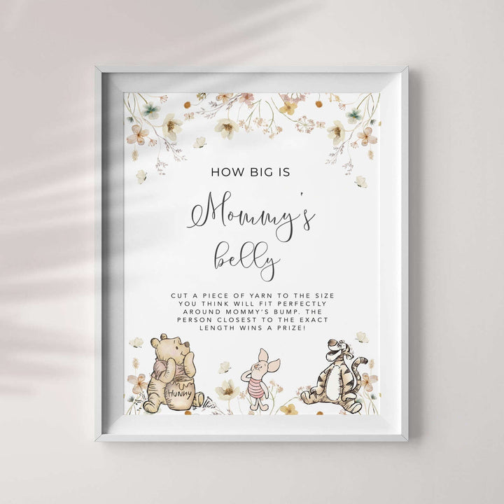 How Big Is Mommy's Belly Game featuring Winnie The Pooh characters in a floral frame for gender-neutral baby shower fun.